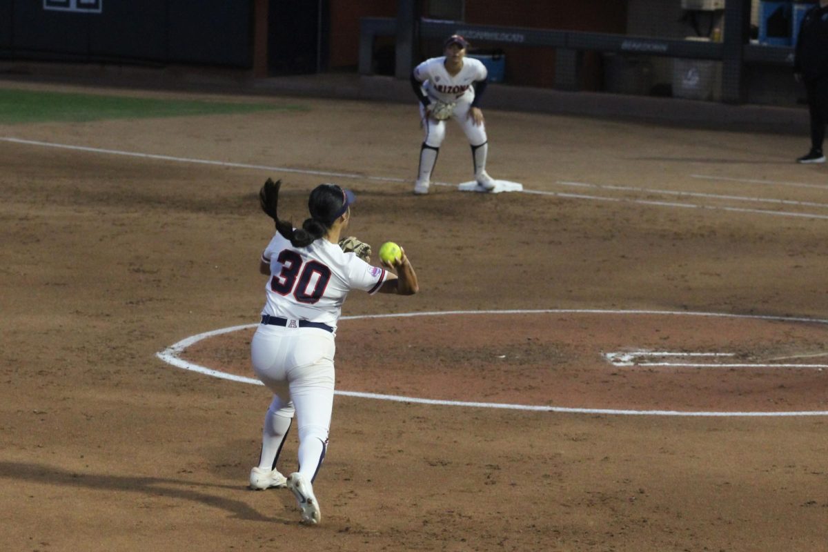 Arizonas Blaise Biringer throws the ball to Carlie Scupin at first base at the Hillenbrand Invitational against Drake on Feb. 22. Scupin catches the ball and gets Bulldog Allie Bishoff out at the end of the top of the second.