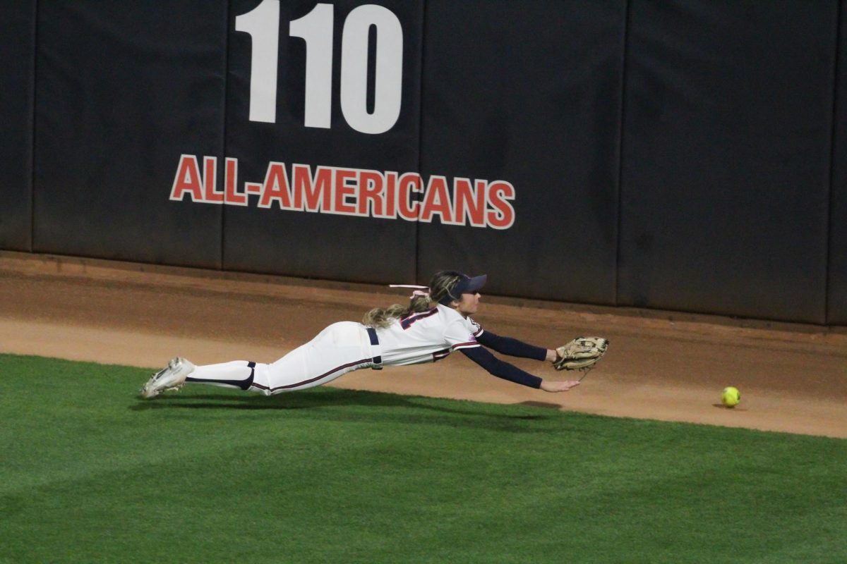 Arizonas Jasmine Perezchica dives for the ball in right field during the seventh inning at the Hillenbrand Invitational against Drake on Feb. 22. Perezchica is able to retrieve the ball and throw it infield.