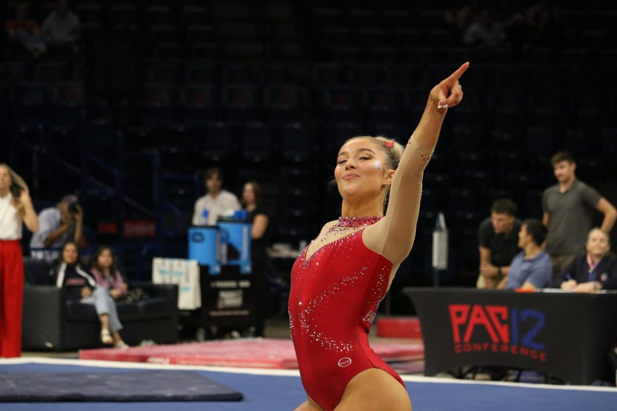 Emma Strom performs her floor routine against Southern Connecticut State University in McKale Center on March 13. Strom performed to hit ‘80s songs like “Come on Eileen” and “Tainted Love.”

