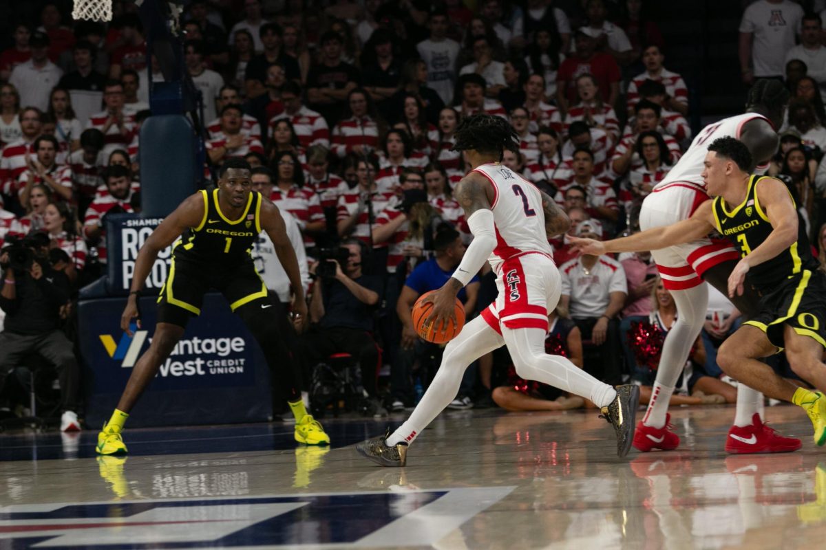 Caleb Love dribbles the ball against facing opposition from the Oregon defense during the Arizona Wildcats’ game against Oregon in McKale on March 2. Love scored 22 points during the game.