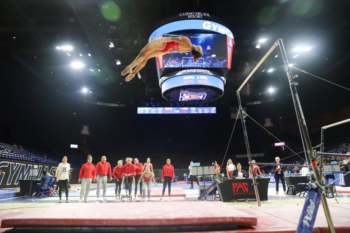 An Arizona gymnast flies through the air as she dismounts the bars in McKale Center on March 13. She sticks the landing.
