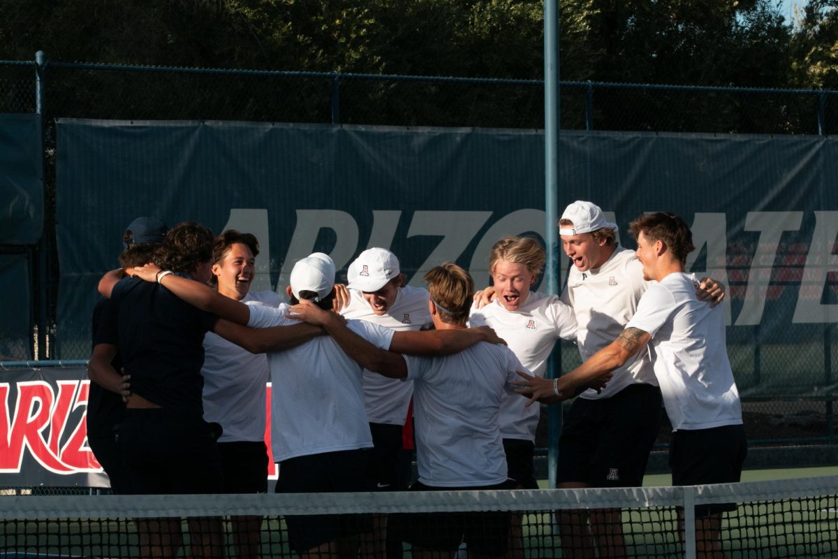 Arizona tennis players celebrate in a circle after defeating Arizona State 4-2 at Robson Tennis Center on April 7. The hard-fought victory came down to a singles match between Gustaf Strom and Max McKennon.