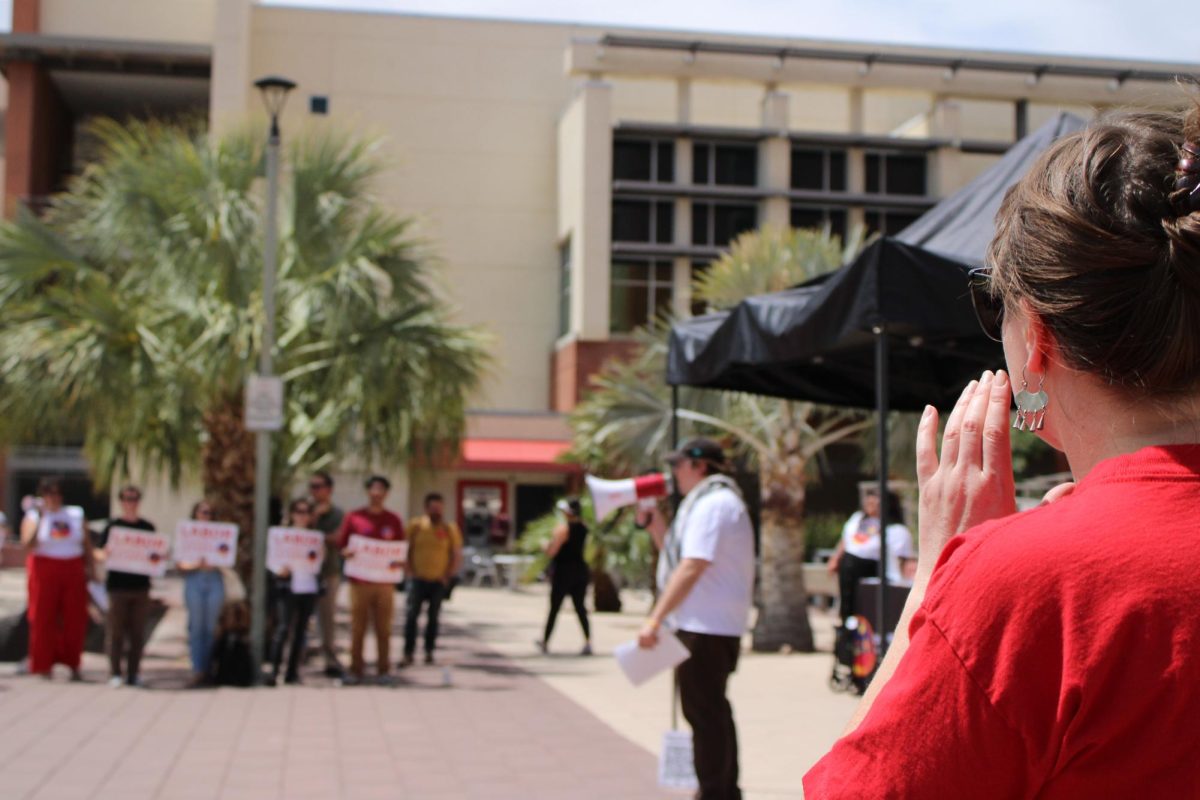 Protestors chant during a rally on April 18 at the University of Arizonas Administraion buidling. The crowd chanted Whose campus is it? in protest of layoff threats and university budget policies.
