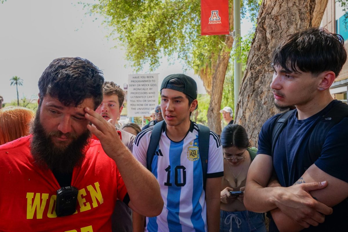 Students gather around UA graduate Dean Frederick Saxton — also known as Brother Dean — as he preached his controversial beliefs on campus on April 22. Dean had been arrested for assaulting a UA student in 2016.
