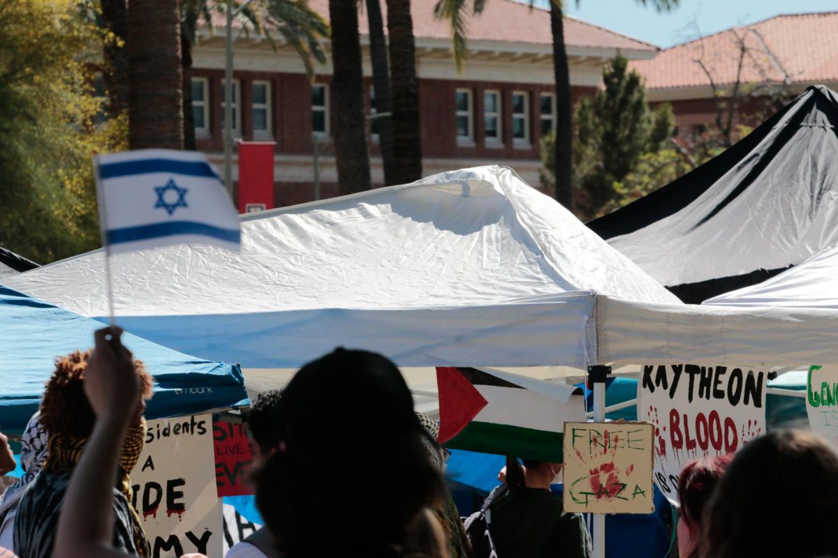A counter-protester holds up an Israeli flag in front of the pro-Palestinian tents on the University of Arizona Mall on April 29. As of the afternoon, only a half dozen counter protesters chanted in front of the megaphones asking, “What about the hostages?”
