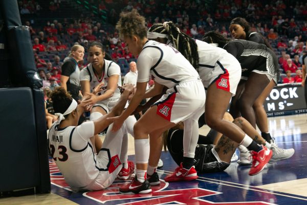 Wildcats players help Maya Nnaji up off the ground as Lady Buffs players do the same to Azia Himeur after an intense play during their game in the McKale Center in Tucson on Oct. 25. The Wildcats came out swinging with an intense offense lasting all the way through the first half.