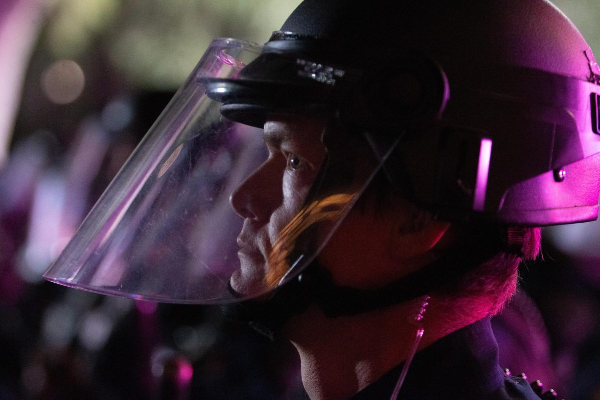 A police officer wearing riot gear prepares to make the first steps against the protestors on Park Avenue on May 1. Police officials said that throwing objects at officers would not be tolerated.
