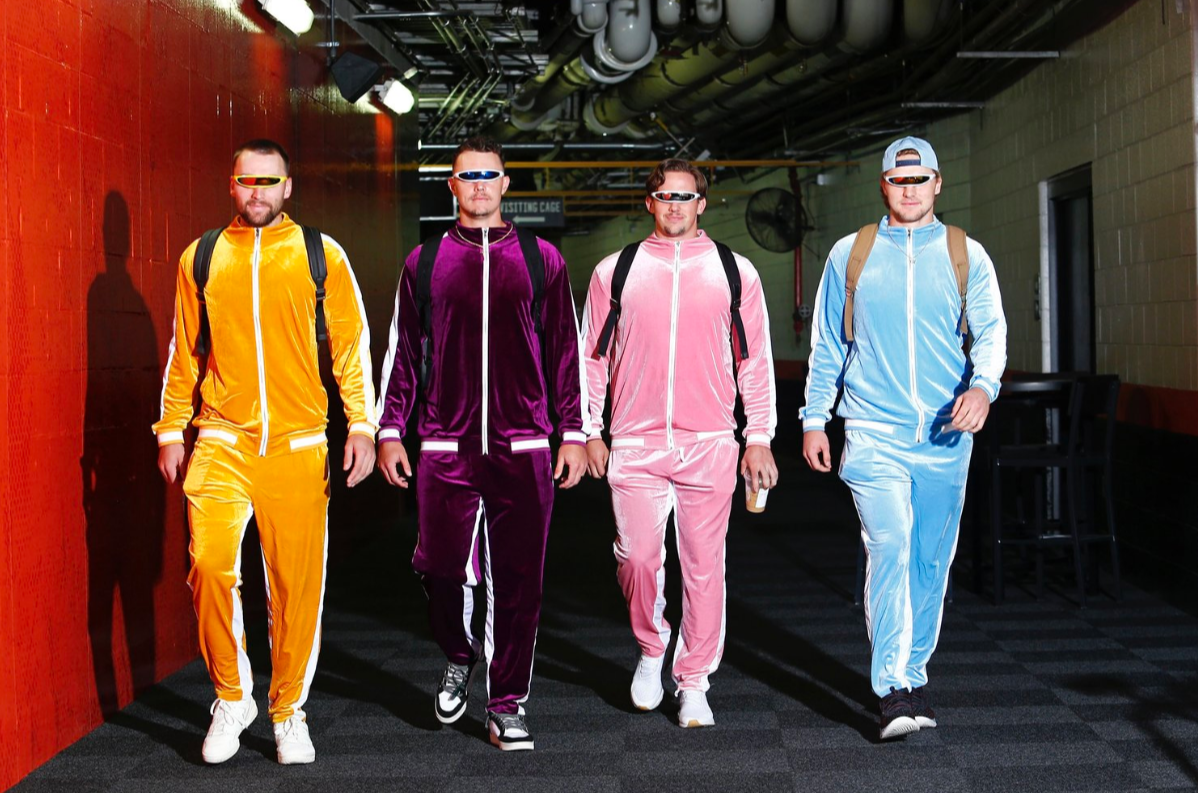 Photograph taken of Colton Cowser, Ryan Mountcastle, Adley Rutschman, and Gunnar Henderson strutting down in different colored, yet matching, velour tracksuits by Baltimore Orioles Photographer, Sammy Frank. Courtesy of Sammy Frank.