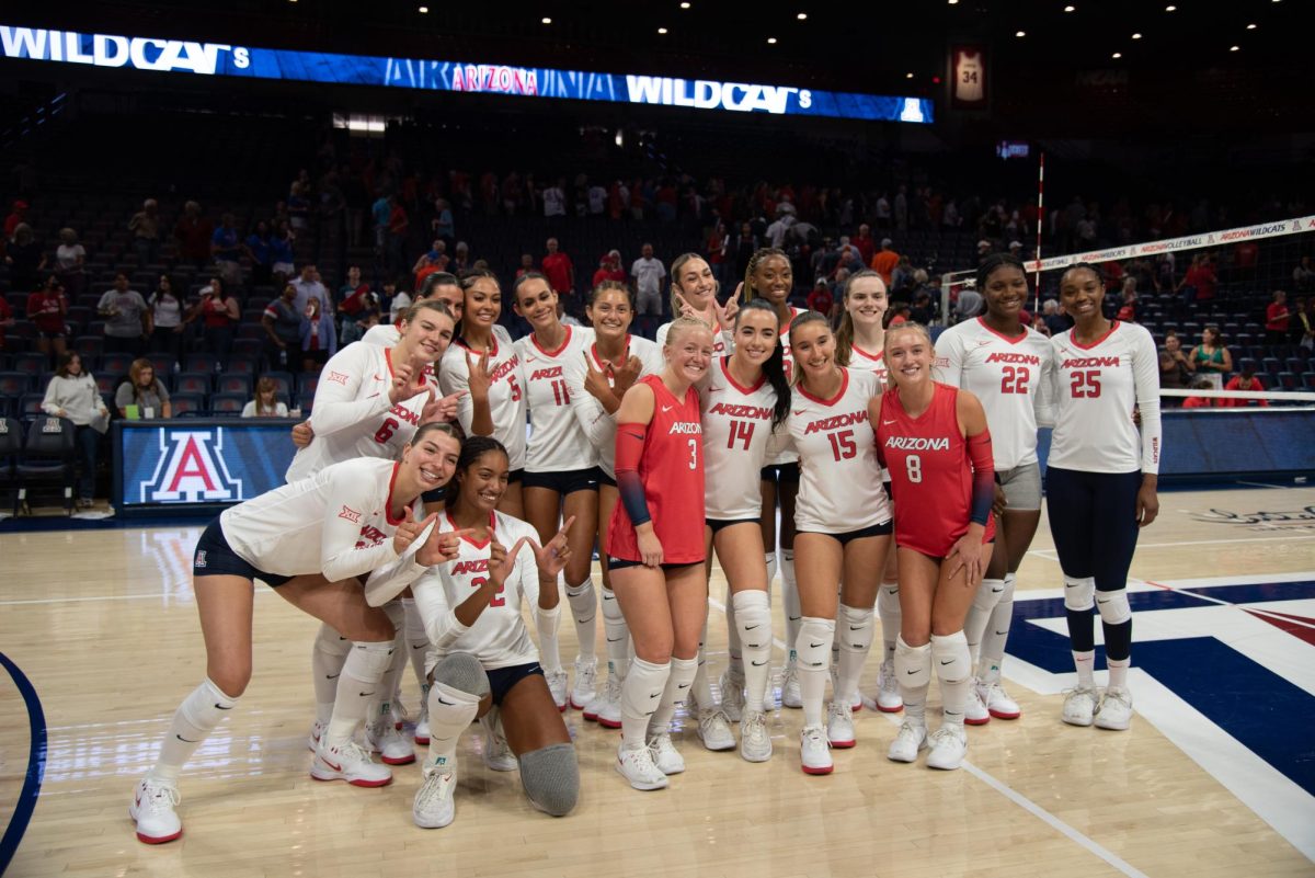 The University of Arizona's women’s volleyball team poses for a group photo after their victory on Aug. 30. The team celebrates their opening season win.