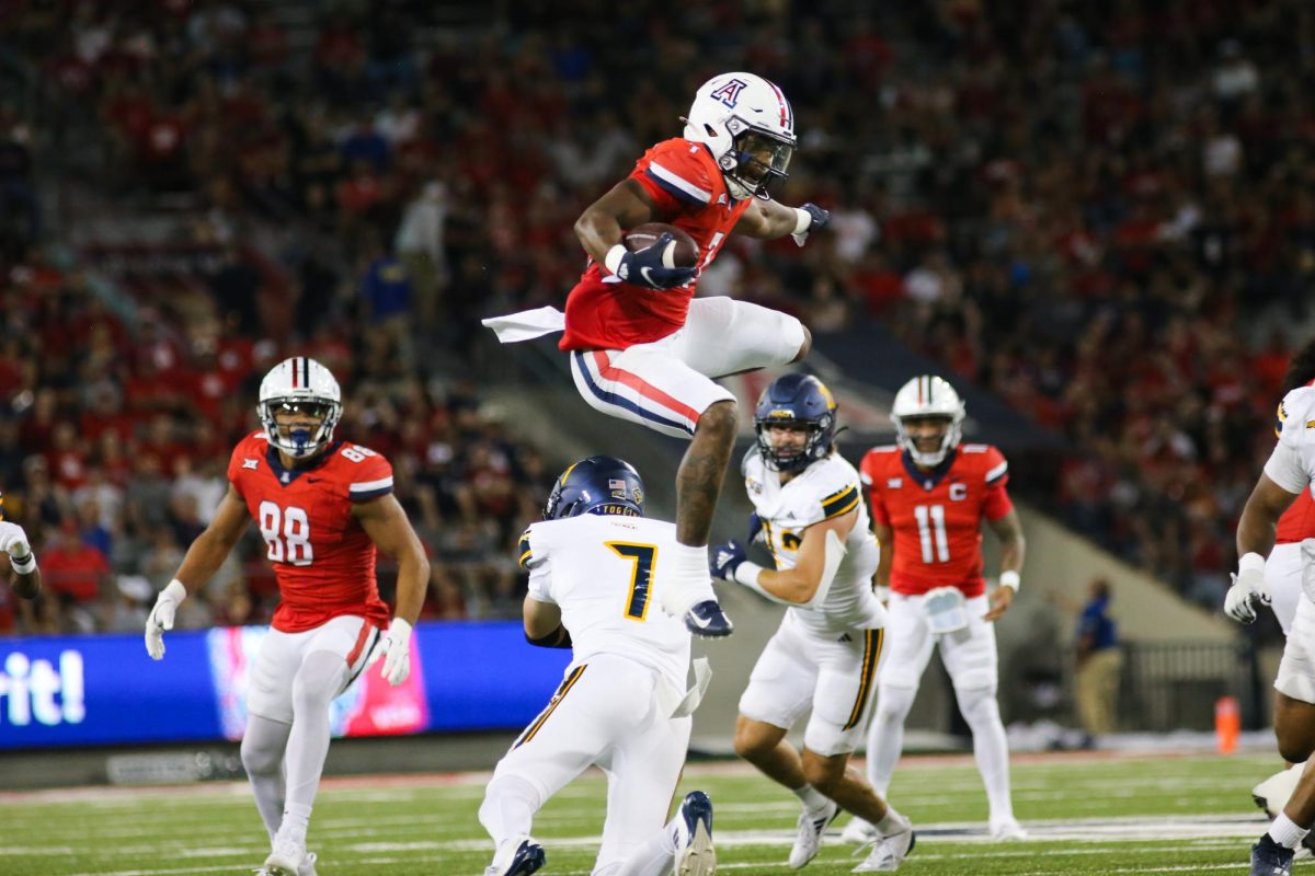 Quali Conley hurdles an NAU defender while making a run down the field on September 7 at Arizona Stadium. Quali totaled 112 rushing yards but no touchdown.