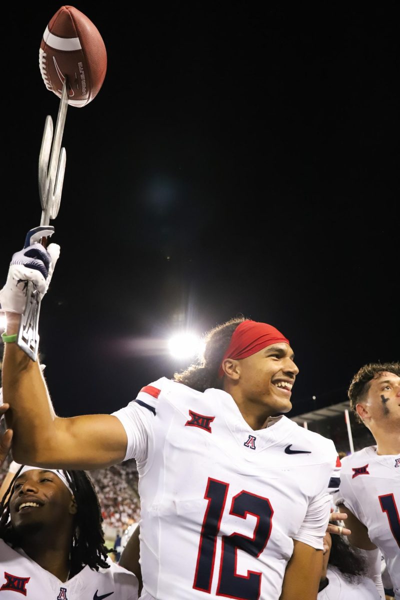 Genesis Smith hoists the "Turnover Sword" after an interception against New Mexico on Aug. 31 at Arizona Stadium. New Mexico gave up two turnovers on the night.