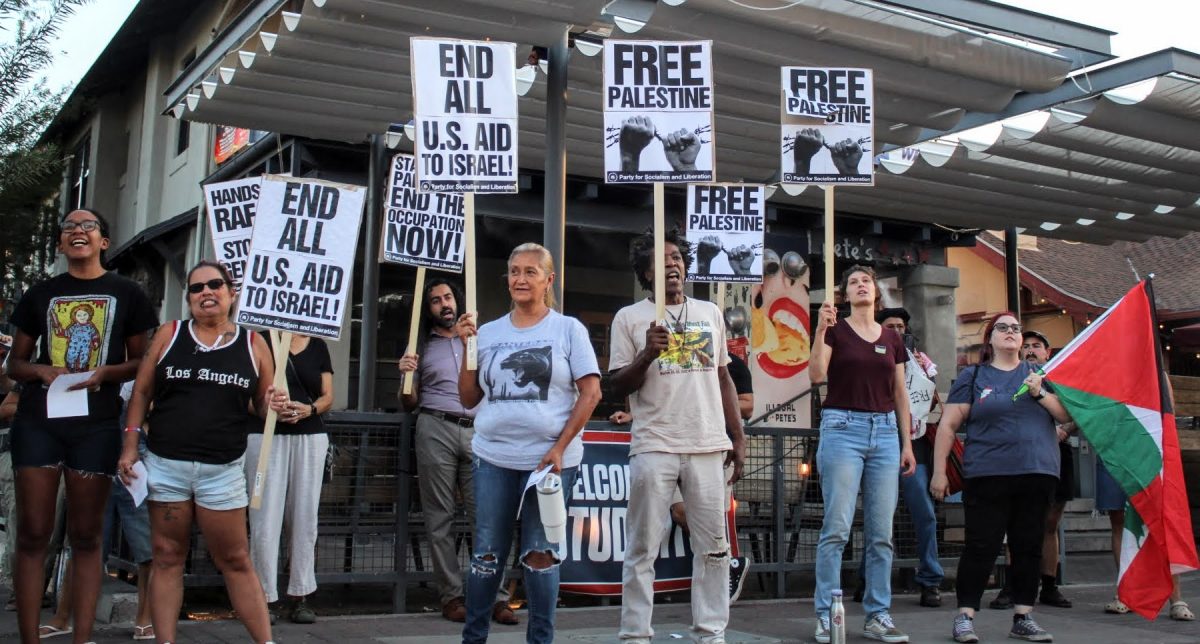 Protesters stand outside of Illegal Pete’s on University Boulevard to stand for their support for Palestine on Sept. 24. The protest was for the “All Out For Lebanon” march, where people all across the United States spoke out against the war.