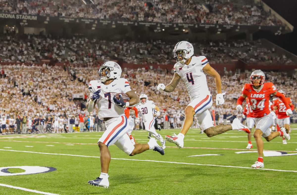 Quali Conley runs in a touchdown with Tetairoa McMillan trailing to start the second half against New Mexico on Aug. 31. Arizona finished the game with eight touchdowns.