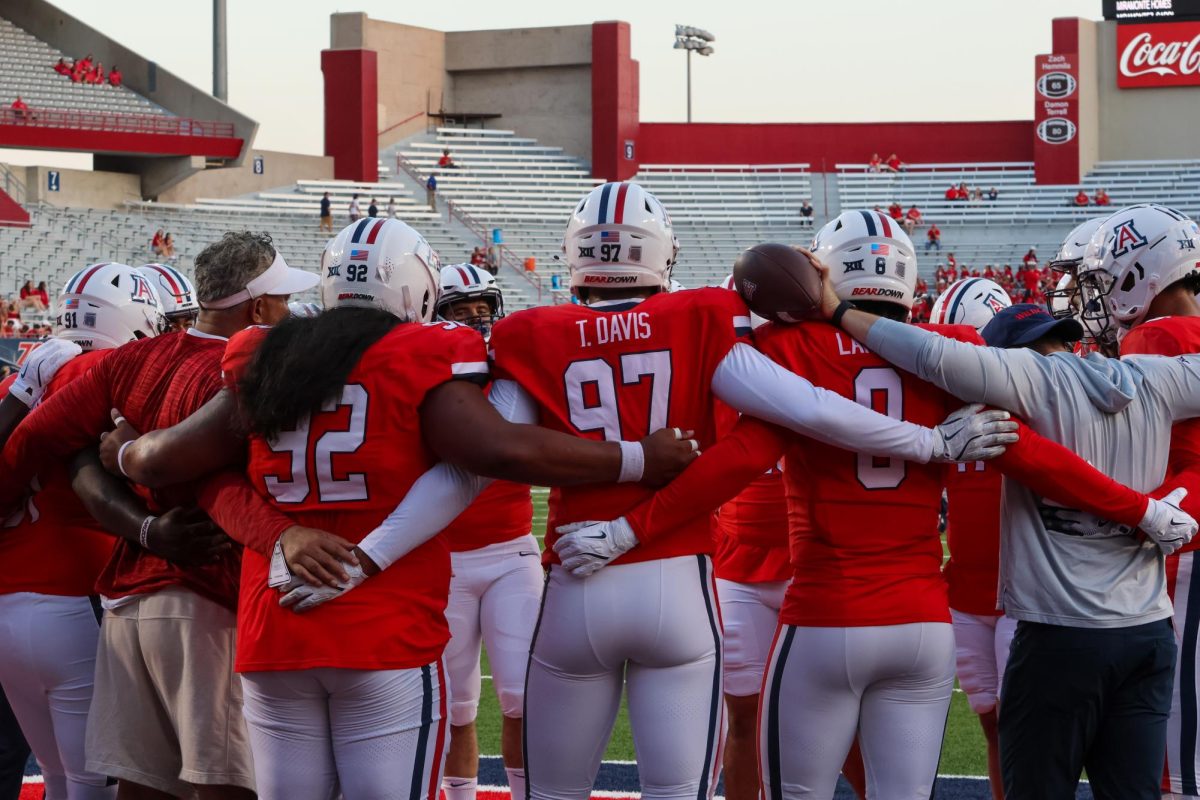 The Arizona football team gather in a huddle before a game against NAU Sept. 7. the Wildcats completed a major upset against the No. 10 Utah Utes in a Big-12 conference matchup Sept. 28.