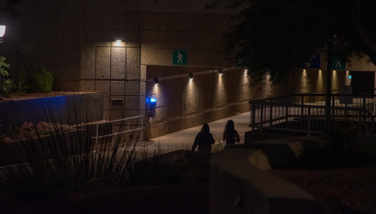 Two students walk at night toward the campus underpass on Oct. 10. Walking with a friend at night is a precaution encouraged by UA safety officials.