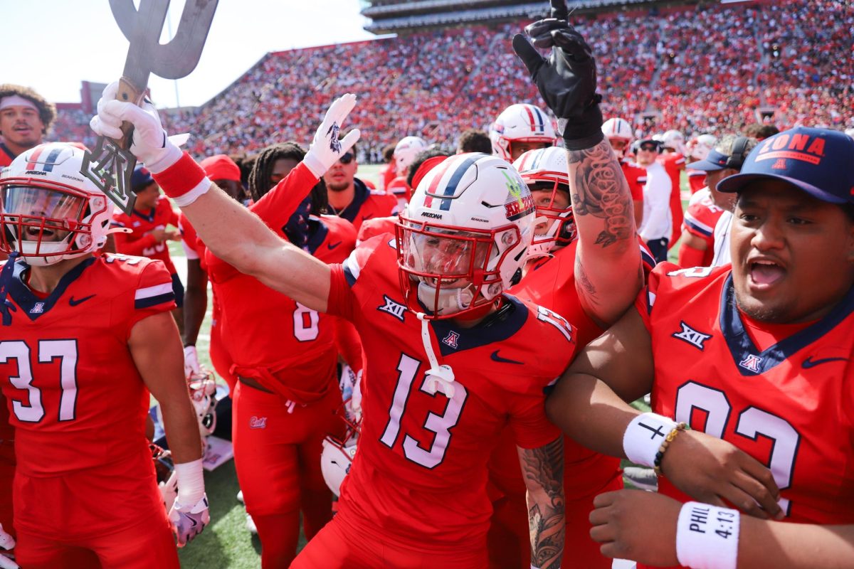 Jack Luttrell celebrates with the team after an interception in the first half against the University of Colorado on Oct. 19. Colorado gave up two interceptions against the Wildcats.