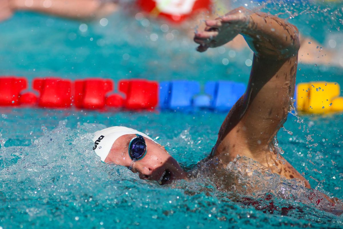 A female swimmer competes in a freestyle race against the University of Utah on Oct. 26. Arizona women's team beat Utah at the multi-day meet.