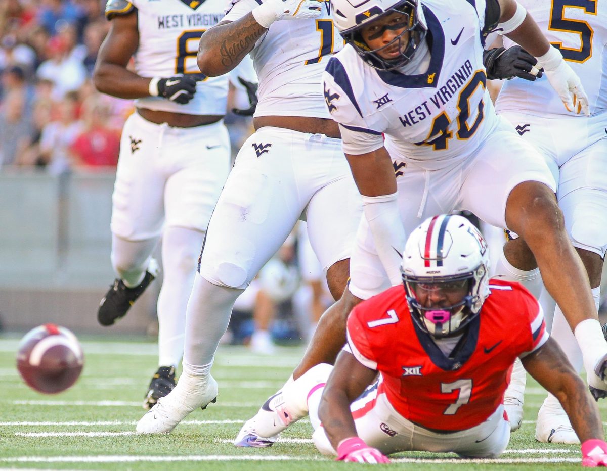 Quali Conley fumbles the ball on the first drive of the game against West Virginia at Arizona Stadium on Oct 26. arizona lost the game 26-31 after a late game rally in the 4th quarter.