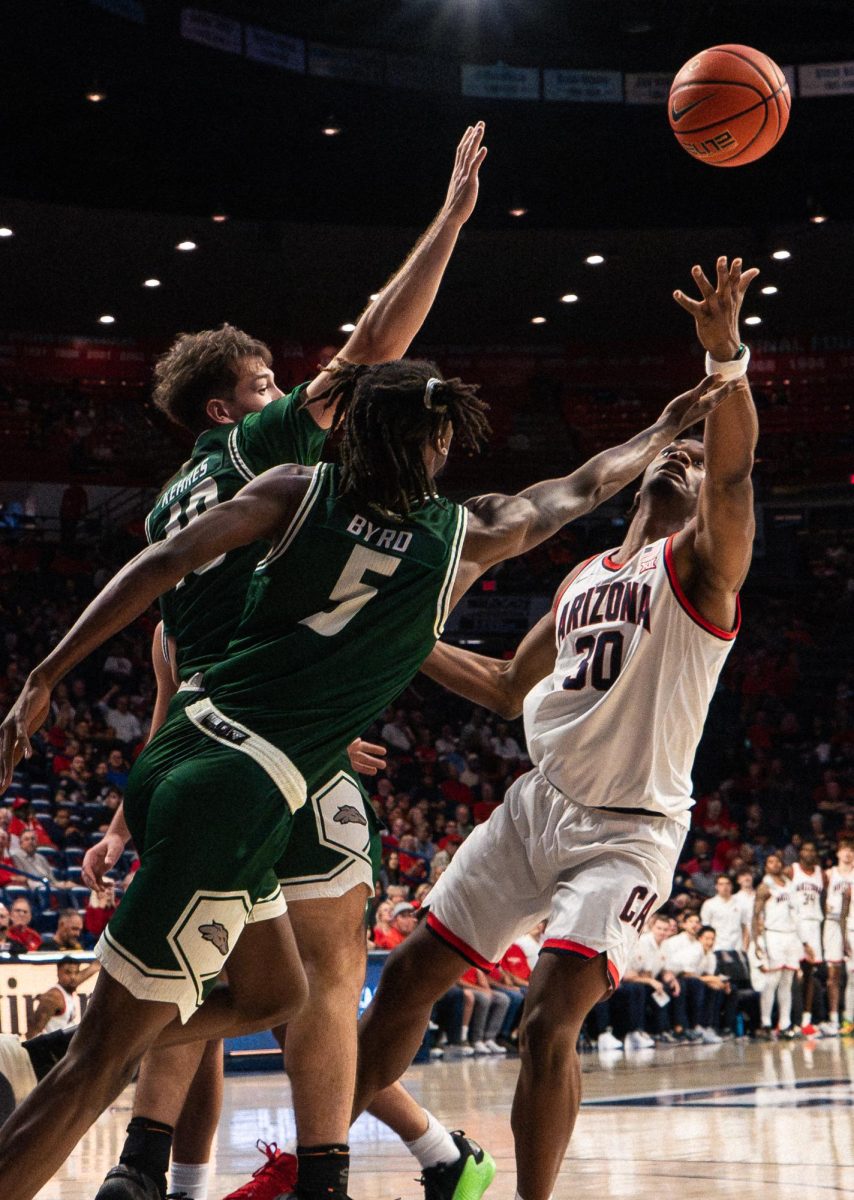 University of Arizona's Tobe Awaka fights for the rebound off the hoop in McKale Center on Oct. 21 for the men's basketball exhibition against Eastern New Mexico. The Wildcats won 117-54.