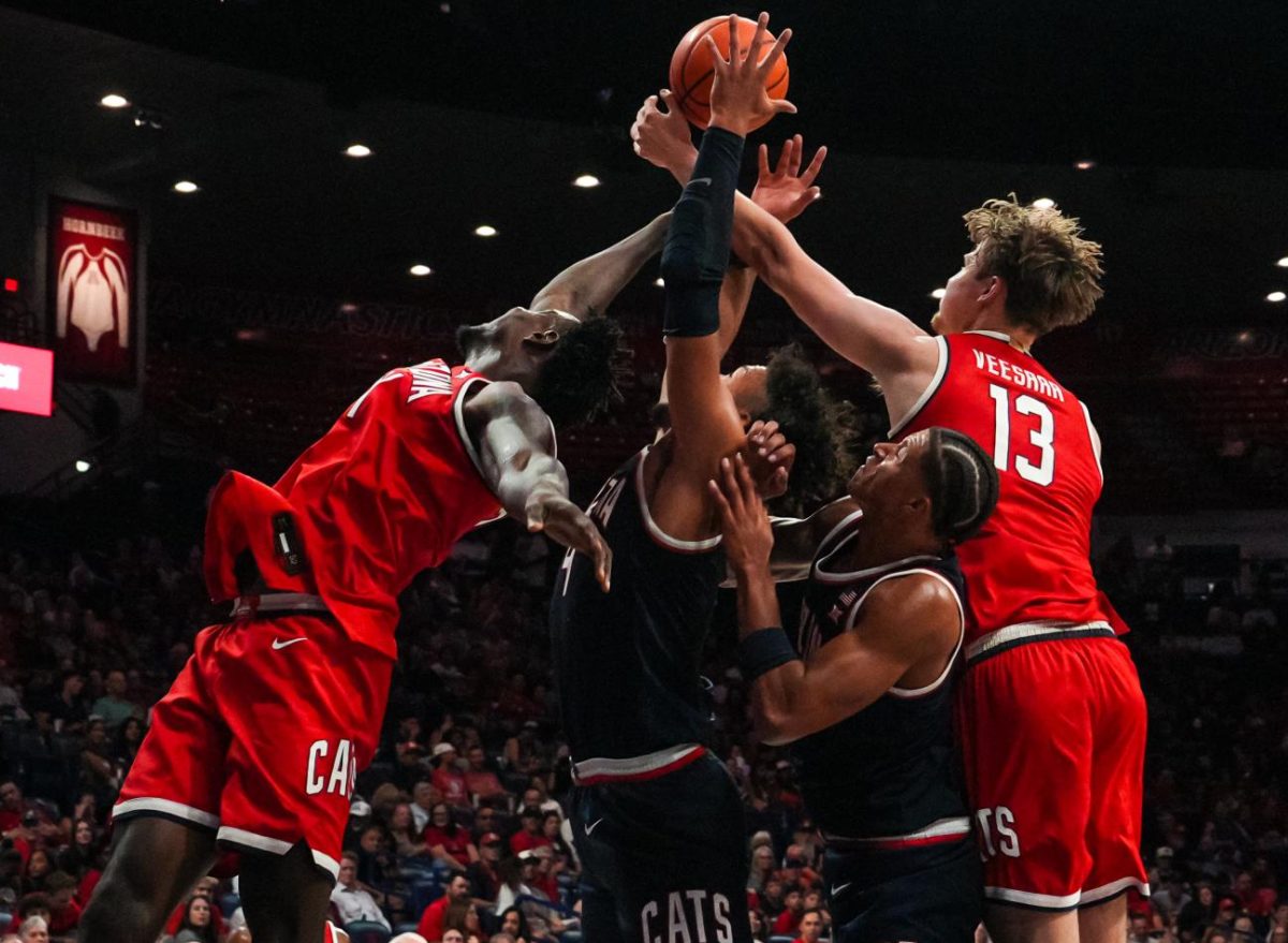 Two players from the Arizona men's basketball team fight for a rebound at McKale Center on Oct. 4 during the Red-Blue Showcase where the Red team won47-44. The Wildcats showcased a 3-point contest and a dunk contest before the scrimmage.