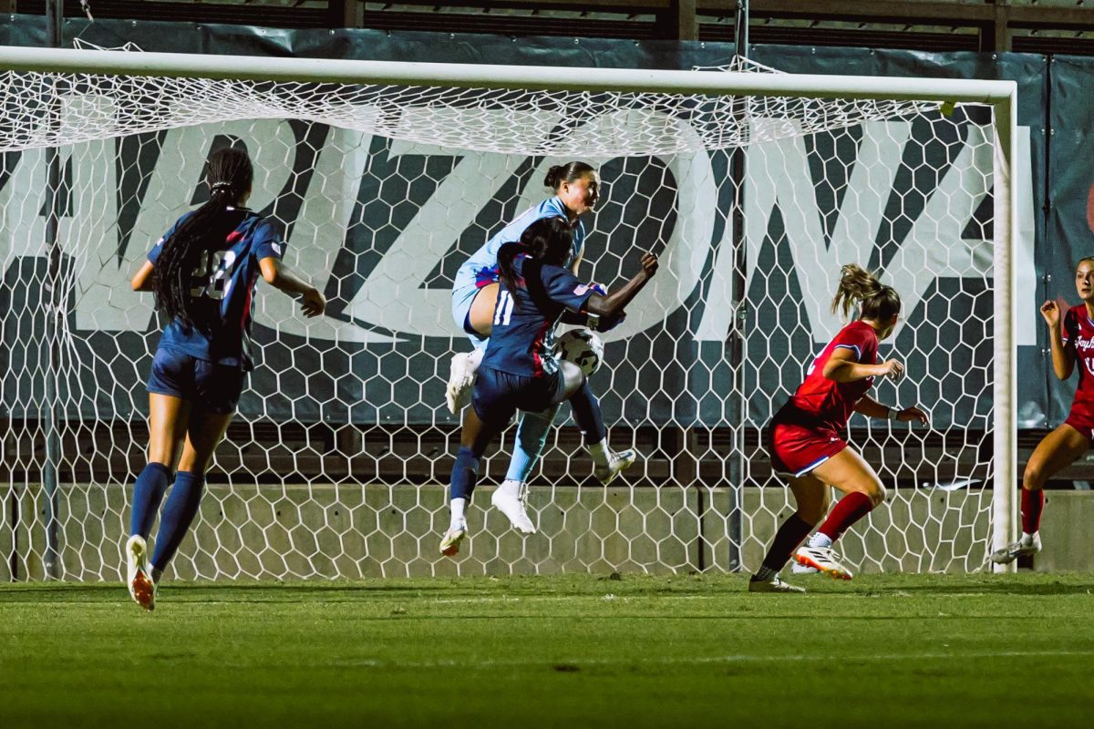 Arizona Wildcats soccer player Nyota Katembo gets personal with the Kansas Jayhawks goalkeeper during a shot attempt at Murphy Field on Oct. 17. Katembo has one shot.