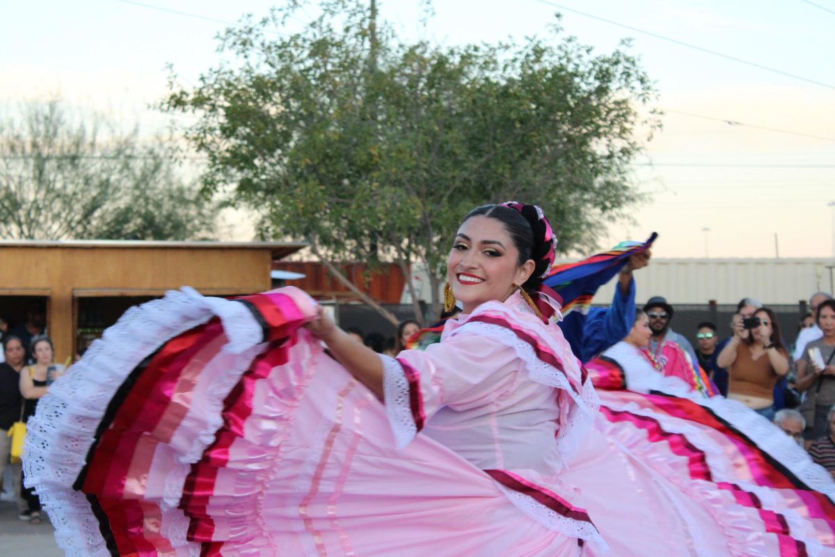 A woman dancing folklorico smiles during her performance at the Cultura x Chicano Vibez festival on Oct. 27 at the MSA Annex. Folklorico is a traditional Mexican folk dance.