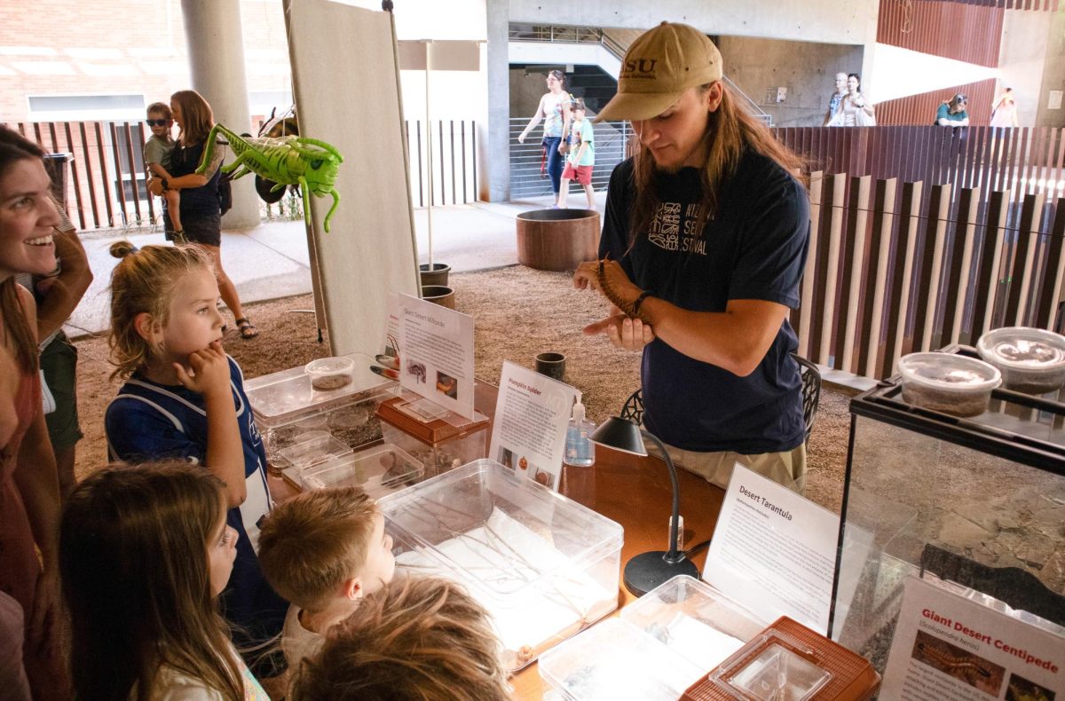 Tyler Boehmer shows off a giant desert centipede to a group of children at the Arizona Insect Festival on Oct. 1 2023. The centipede is the largest found in north America, and holds the most venom.
