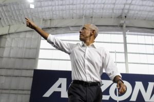 Former President Barack Obama enters the stage inside the Cole and Jeannie Davis Sports Center on Oct. 18. Obama, accompanied by state and local candidates and politicians, spoke to thousands on the UA campus.