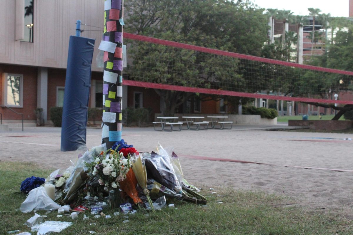 A memorial is set up for Minhaj Jamshidi at the volleyball court outside of Arizona Sonora Hall on Sept. 26. Jamshidi was shot on Sept. 22 while playing volleyball. 