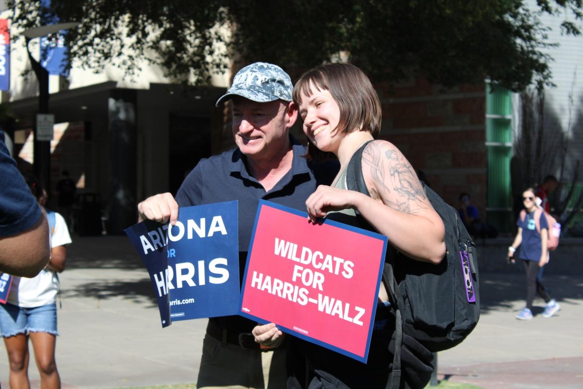 Senator Mark Kelly takes a picture with a University of Arizona student on Oct. 15 near the Student Union building. "The difference between winning and losing is to vote," Kelly said about the importance of voting.