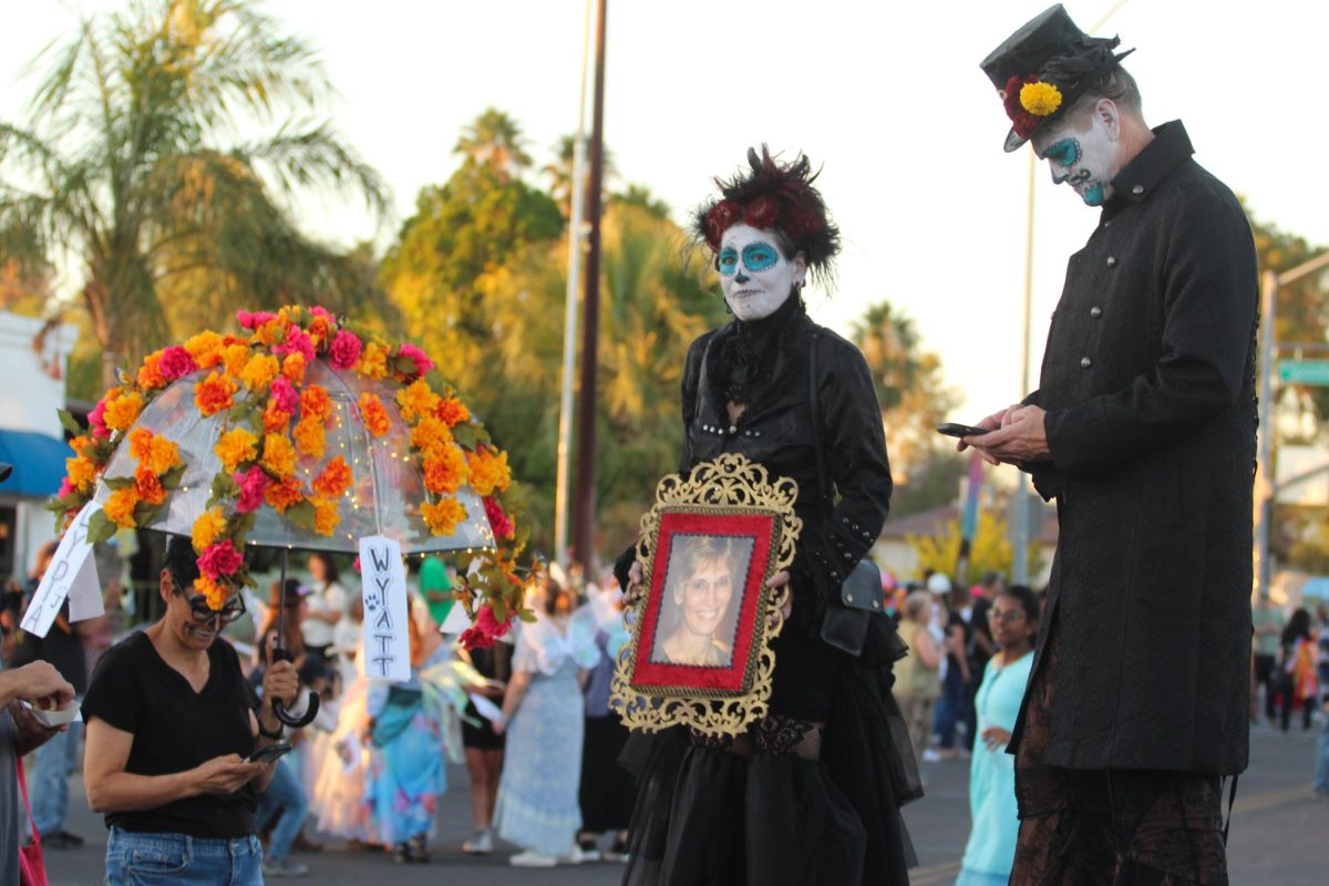  A pair of stilt walkers participate in the 2023 All Souls Procession. The event encourages people to do whatever they need to express their grief.