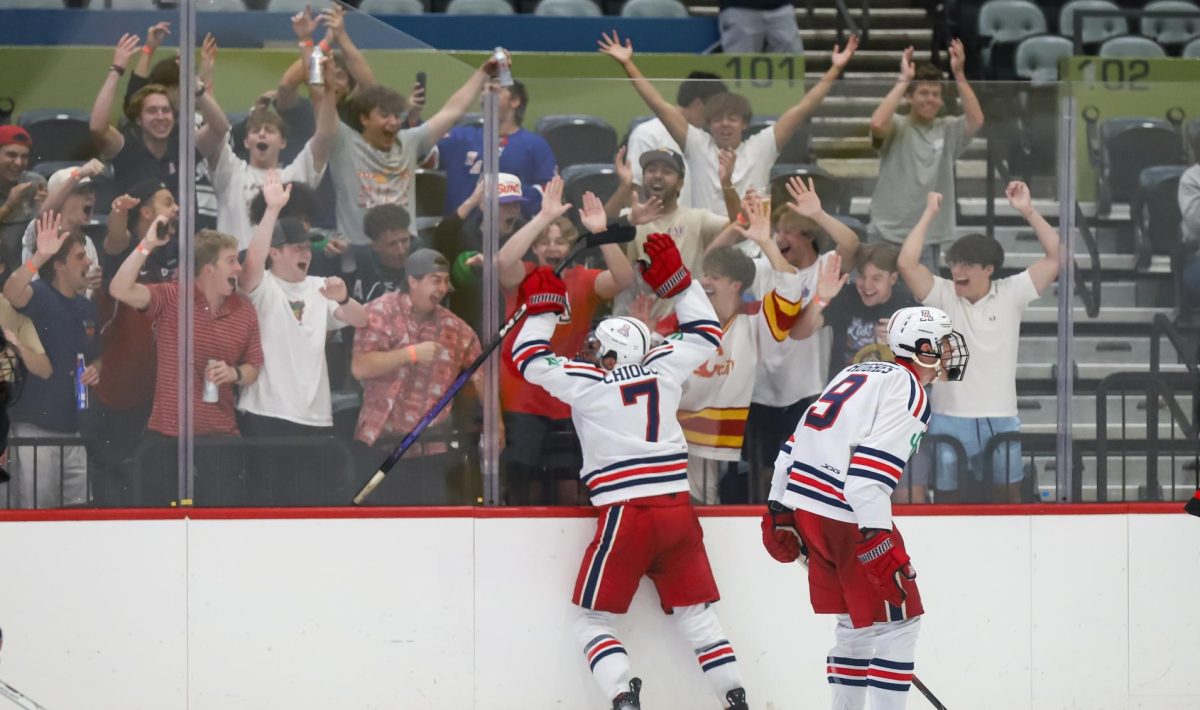 Nicholas Chiocca and Justin Hughes celebrate the team's seventh goal scored by Chiocca in Tucson Arena on Sep. 26. This was the season opener for Arizona.