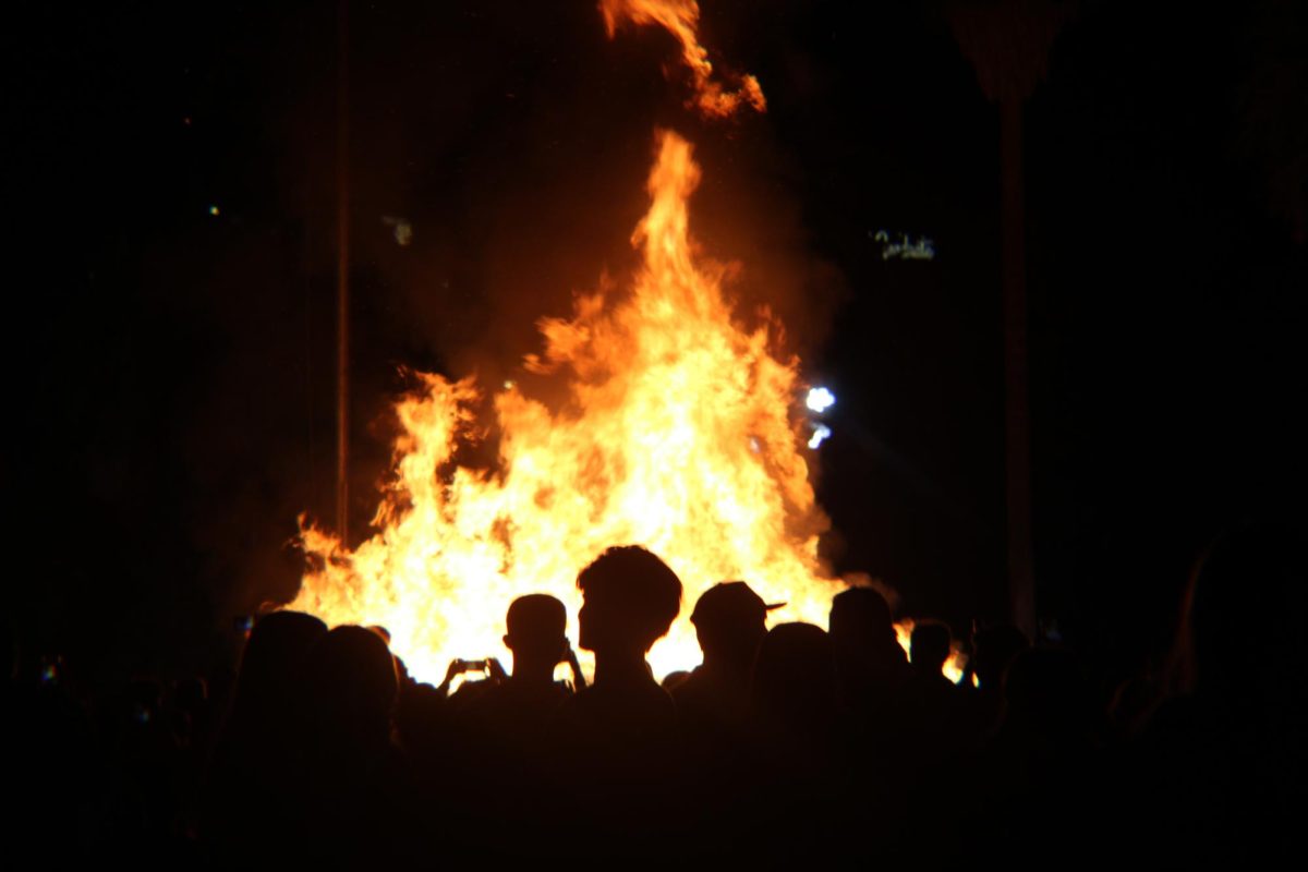 People watch the lighting of the bonfire on Oct. 19 near Old Main on the University of Arizona campus. Prior the bonfire, the Homecoming king and queen were crowned.