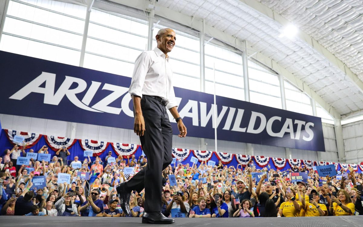 Former President Barack Obama enters the stage inside the Cole and Jeannie Davis Sports Center on Oct. 18. Obama, accompanied by state and local candidates and politicians, spoke to thousands on the UA campus.