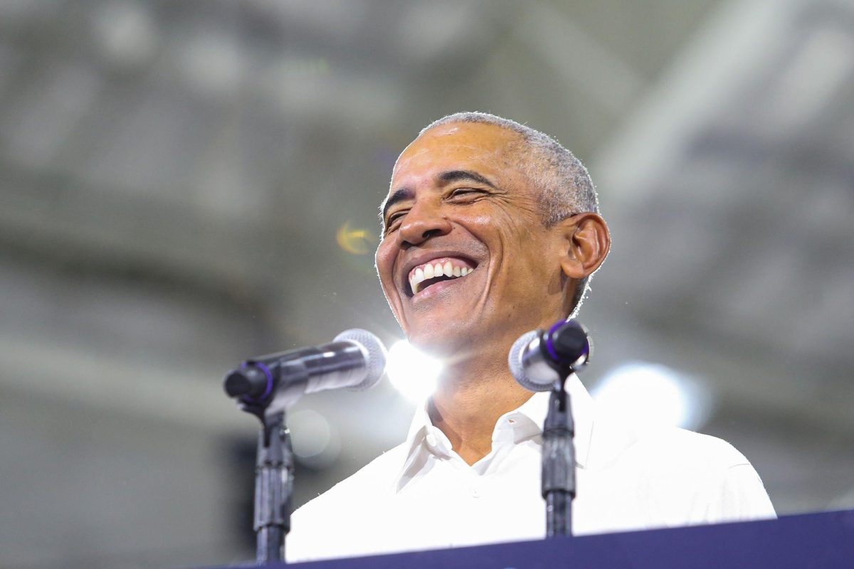 Former President Barack Obama smiles at a rally in the Cole and Jeannie Davis Sports Center on Oct. 18. Obama, accompanied by state and local candidates and politicians, spoke to thousands on the UA campus.