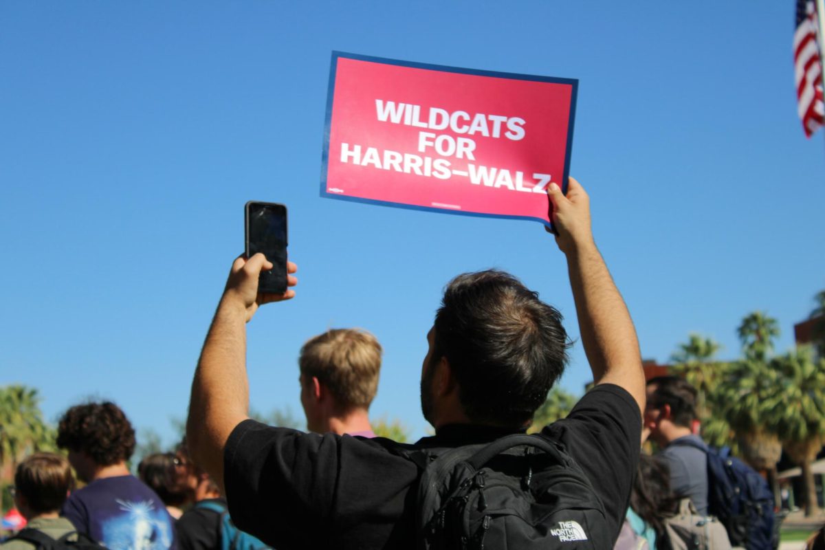 A student holds up a "Wildcats For Harris-Walz" sign on the University of Arizona Mall on Oct. 15. The group wildcats4harris promoted the meet and greet event.