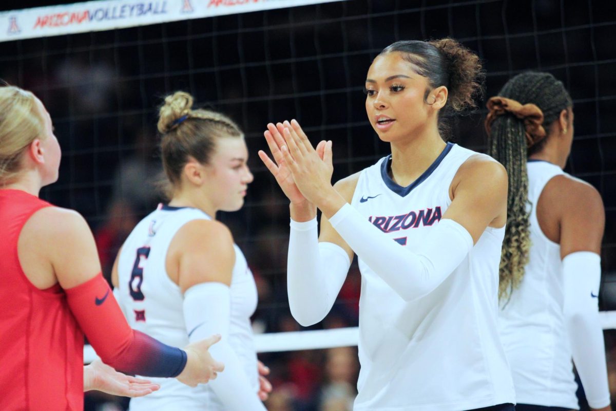 Jordan Wilson, 5, talks to her teammates before set 4 begins on Oct. 2 in McKale Center. All University of Arizona players had over 13 kills.