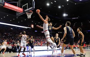 Motiejus Krivas dives in for the layup against Canisus on Nov. 4 in McKale Center. Krivas played in his first game back from injury scoring 9 points in as many minutes.