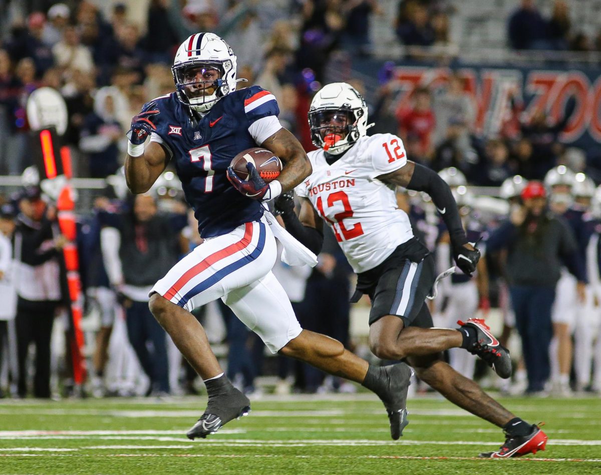 Quali Conley breaks away from the line of scrimmage for another touchdown against the University of Houston on Nov. 15 at Arizona Stadium. Conley's touchdown drive was only 1 play for 50 yards.