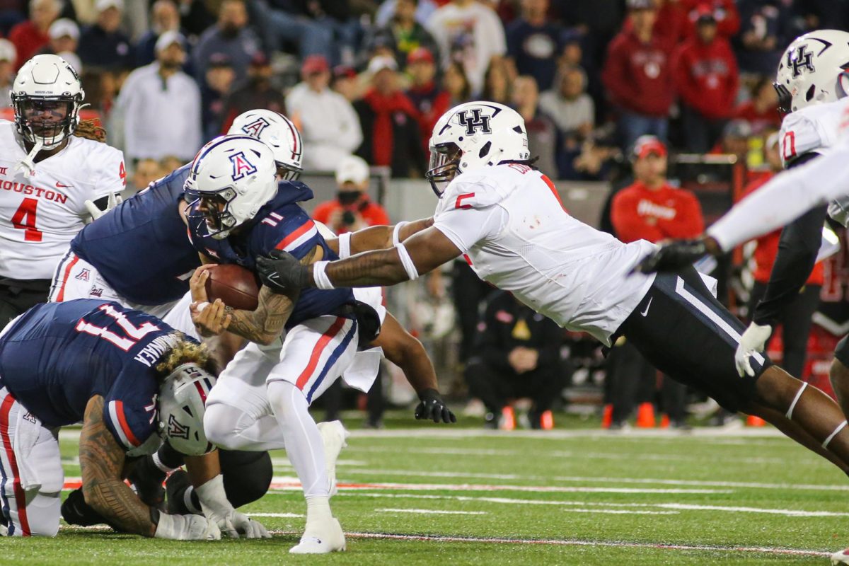 Noah Fifita rushes the ball up the middle against the University of Houston on Nov. 15 at Arizona Stadium. Despite the defensive effort, Fifita was sacked 5 times in the game.