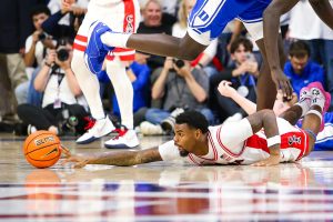 Arizona mens basketball player KJ Lewis reaches for a loose ball against Duke in McKale Center on Nov. 22. Arizona managed to rack up 19 fouls during the game.