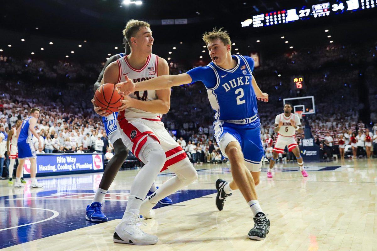 Duke star Cooper Flagg attempts to steal the ball from University of Arizona center Motiejus Krivas early in the second half in McKale Center on Nov. 22. While Krivas secured the ball, Arizona finished the game with 15 turnovers.