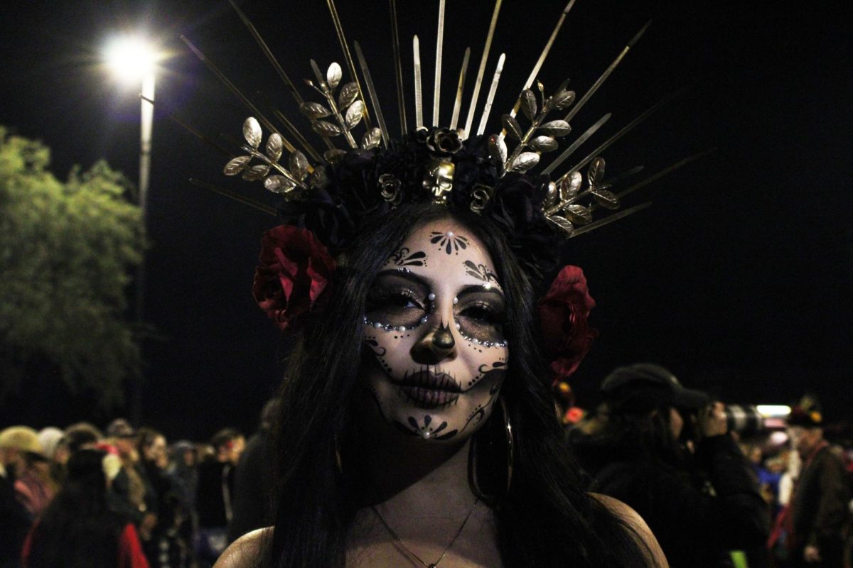 A woman poses with her face painted as a traditional sugar-skull on Nov. 3. at the MSA Annex. Tucson's All Souls procession welcomes everyone to grief their loved ones and celebrate life however they may need. 