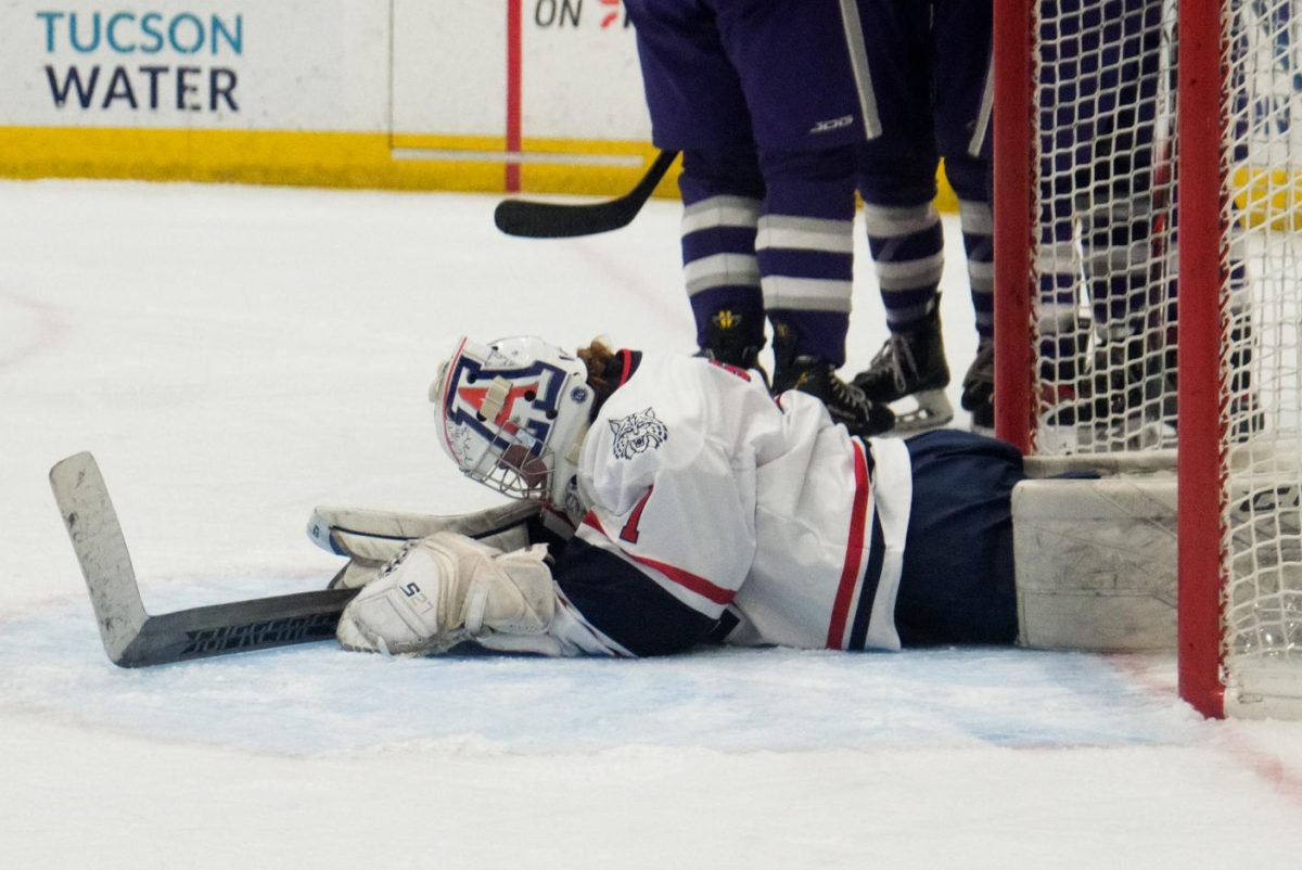 After an overtime loss, goalie Olivia Sorlie lays in the goal in Tucson Arena on Nov. 23. The Wildcats were only two seconds away from a shootout.