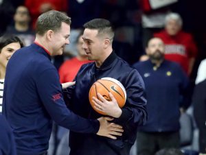 Tommy Lloyd congratulates T.J. McConnell on his Ring of Honor induction in McKale Center on Dec. 18. McConnell graduated UA in 2015 and is now a point guard for the Indiana Pacers.