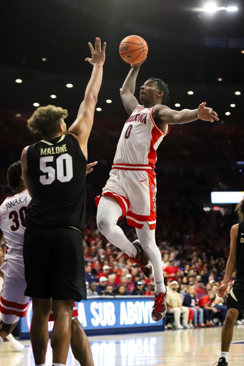 Jaden Bradley attempts to dunk on Colorado center Elijah Malone on Jan. 25 in Mckale Center. Arizona dominated as they lead for a total of 36 minutes.