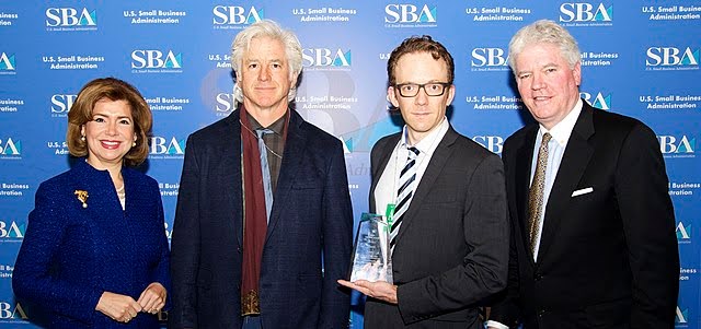 EnChroma executives Don McPherson and Andy Schmeder (center) accept Tibbetts Award from SBA, 2017. Sourced from Wikimedia commons. Posted by EditorZach.