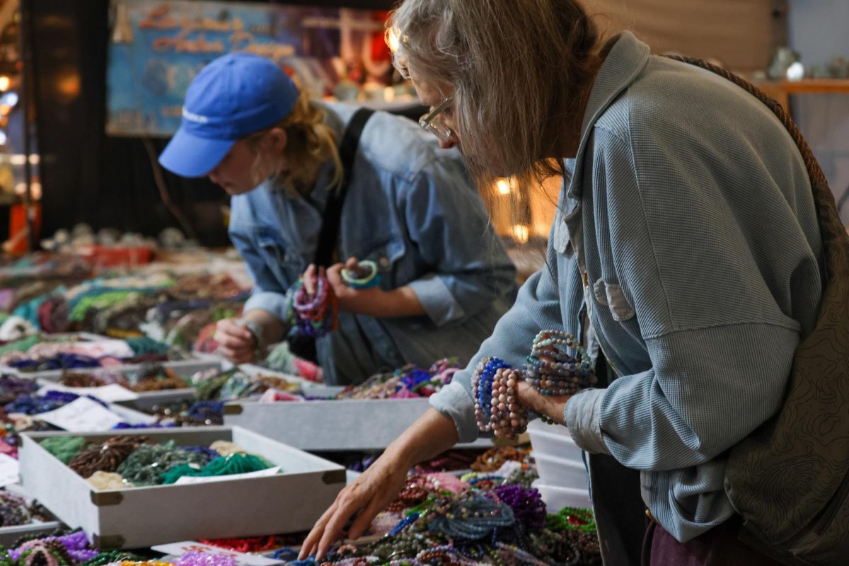 Two people sift through baskets of beads at Tucson's 22nd Street Mineral, Fossil, Gem & Jewelry Show on Feb. 5. The show features items from all around the world in a vast price range.