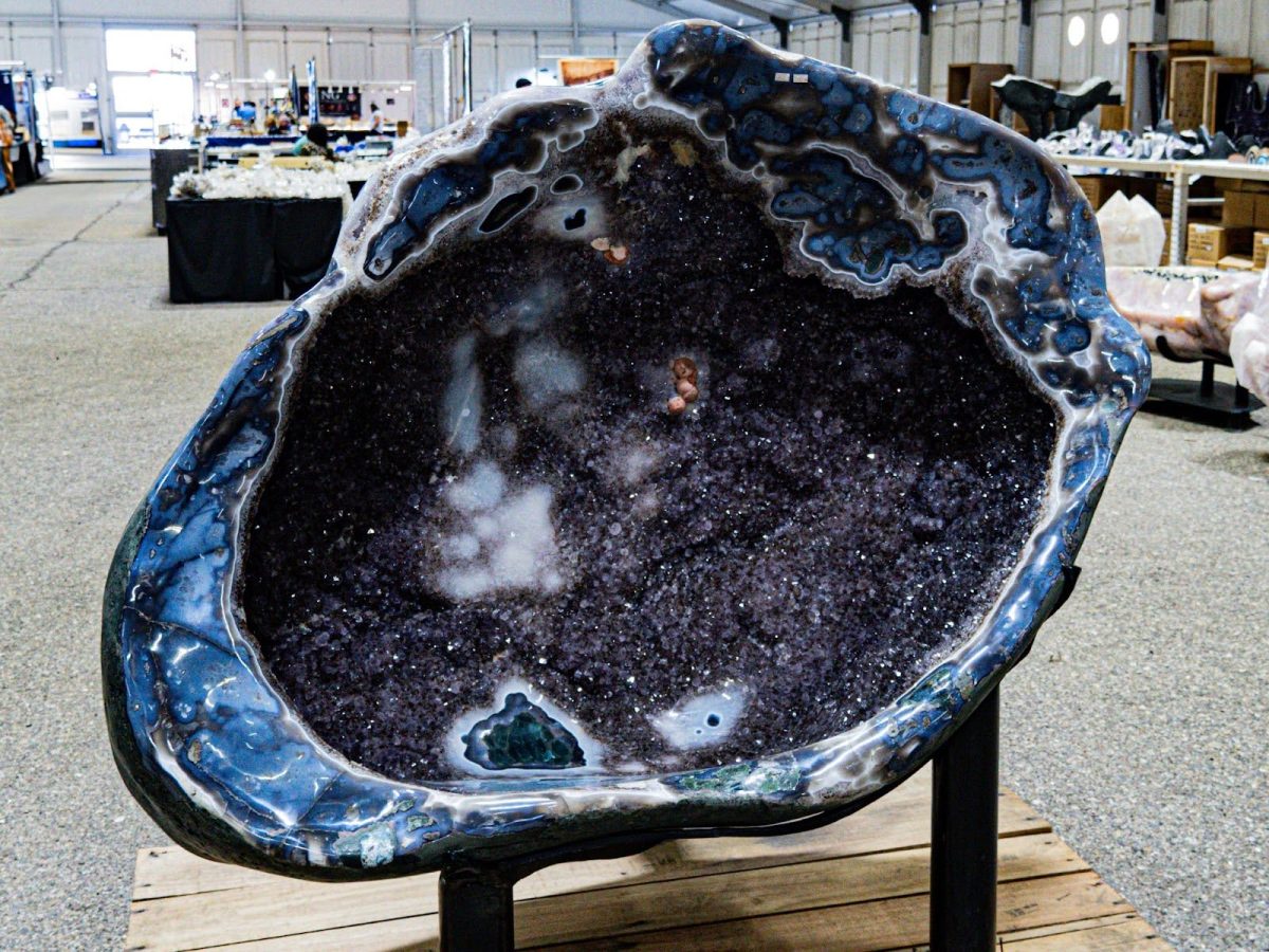 A dazzling, deep purple amethyst geode with sparkling crystals.