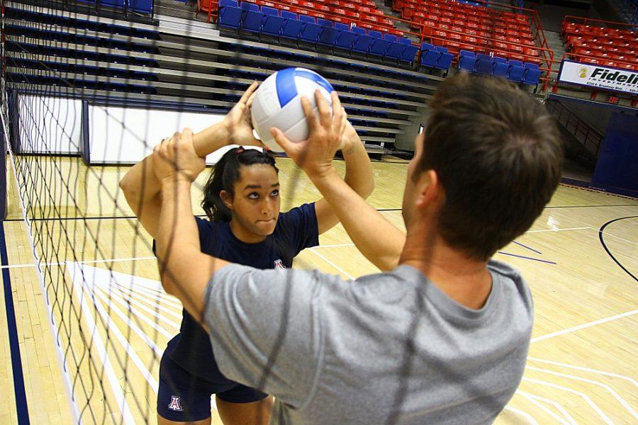 Gordon Bates / Arizona Daily Wildcat
Chloe Mathis, an undecided freshman, gets help form associate head coach Steve Walker as she practices for new position as setter on the Wildcats volleyball team on Tuesday, Sept 20 in McKale Center. Mathis currently has a sprained right ankle, in addition to a condition that has slowed the tendon growth in her left knee.